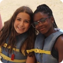 2 girls smiling with life jackets