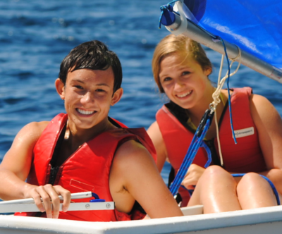 boy and girl sitting in sailboat