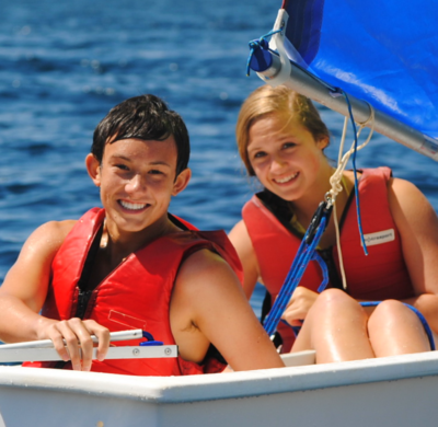 boy and girl sitting in sailboat