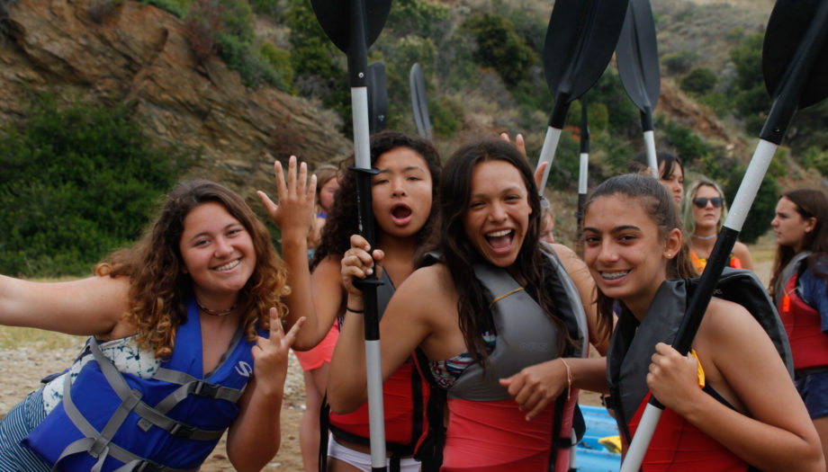 girls holding oars getting ready to kayak