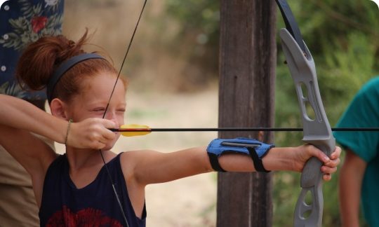 girl aiming bow and arrow