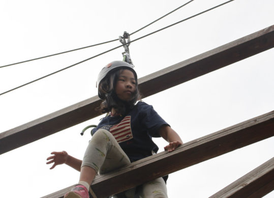 camper navigating the challenge course