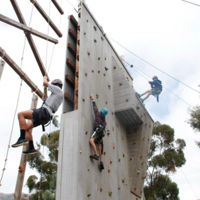 campers climbing and rappelling down from the 30 ft climbing wall