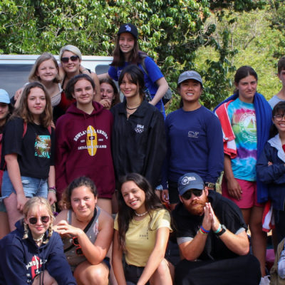 day trip campers gathered in front of the vans