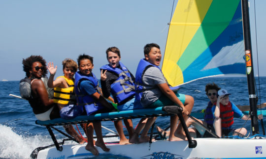 campers having fun on one of the sailboats