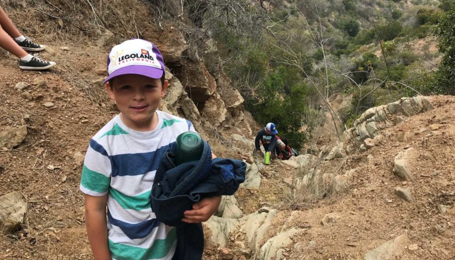 boys climbing a steep hiking trail