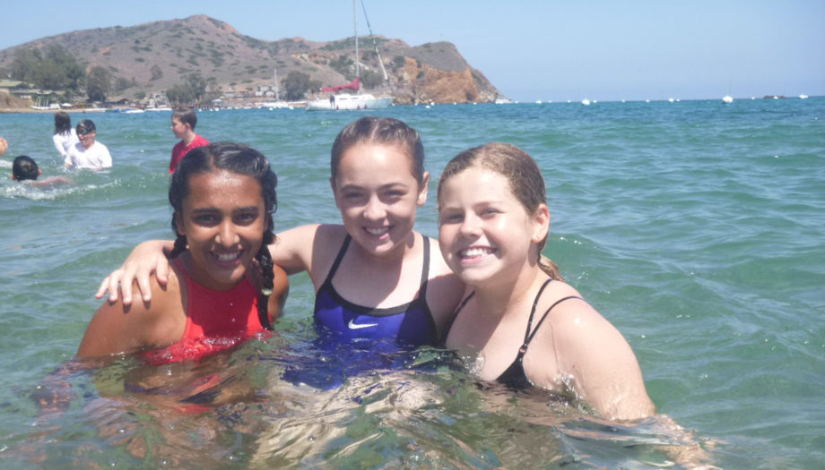 Three campers in the ocean