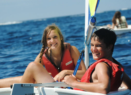 two campers sitting in a sailboat