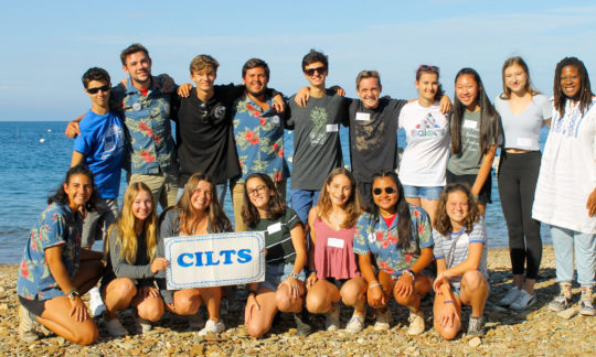Campers in Leadership Trainees in a group photo overlooking the ocean