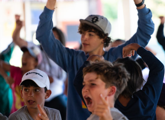 Kids celebrating an announcement at lunch