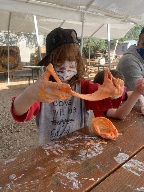 boy playing with orange slime