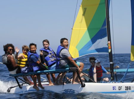 campers and counselors on a catamaran