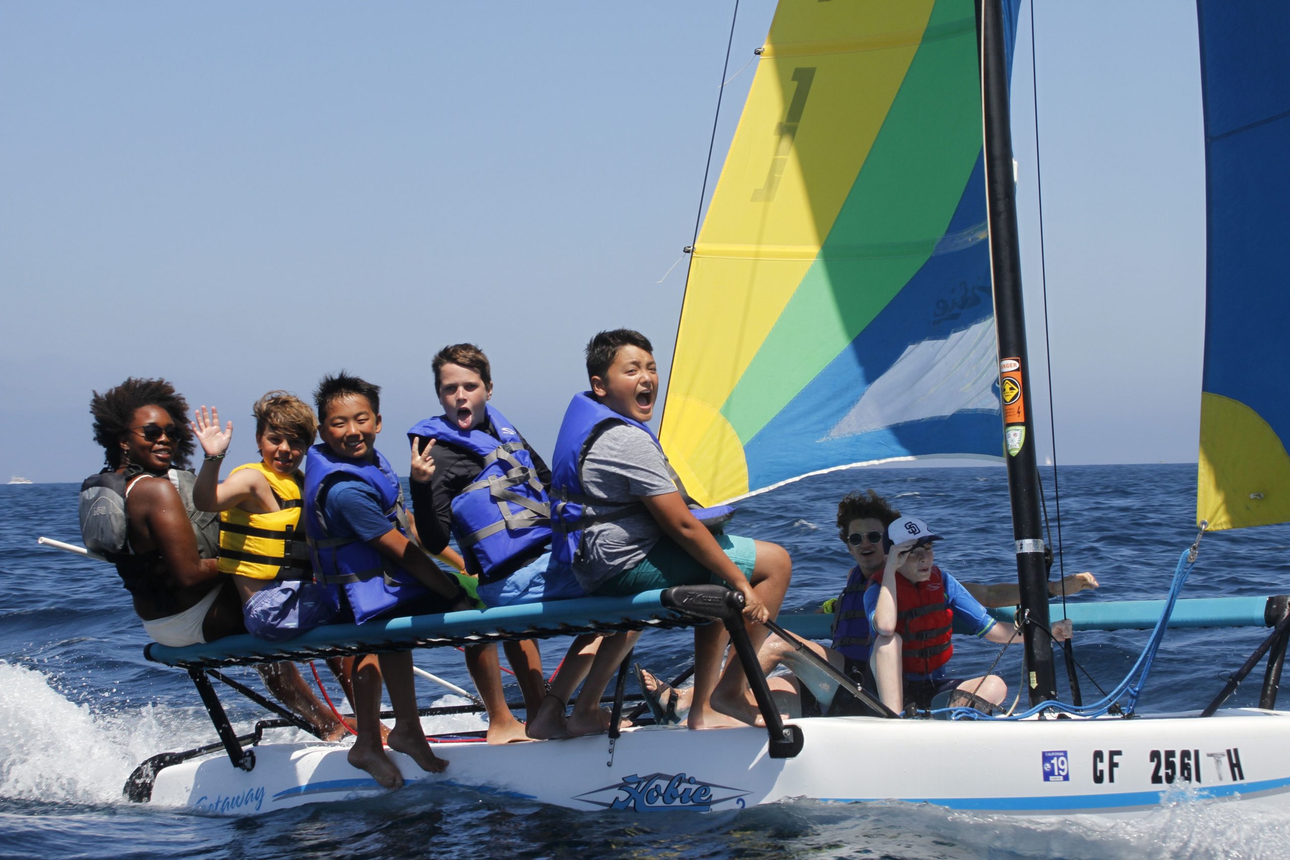 campers and counselors on a catamaran