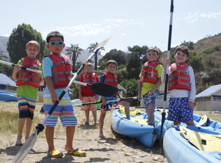6 boy campers posing with kayak paddles