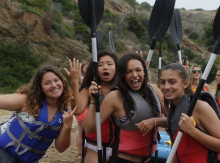 4 girls holding kayak paddles